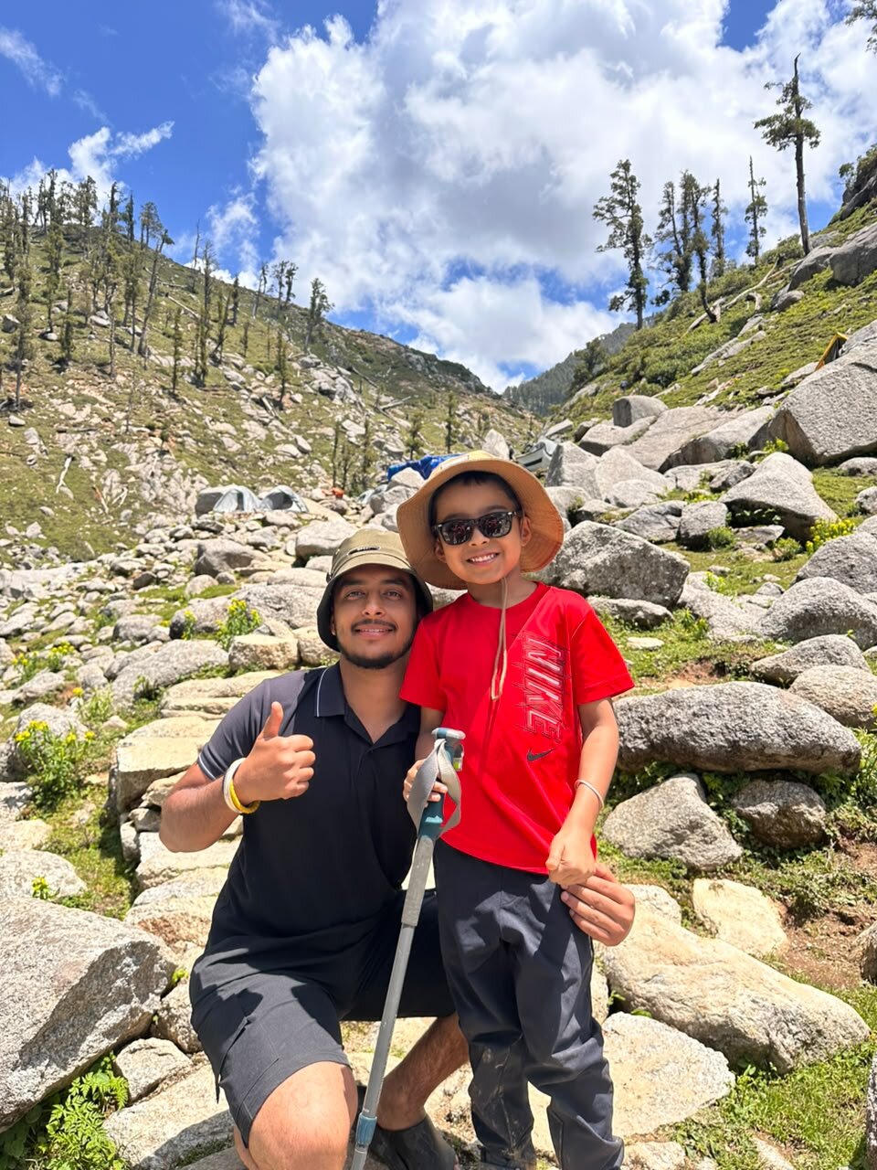 Yuvan in a red shirt with his new friend Rhythm on the way to the campsite