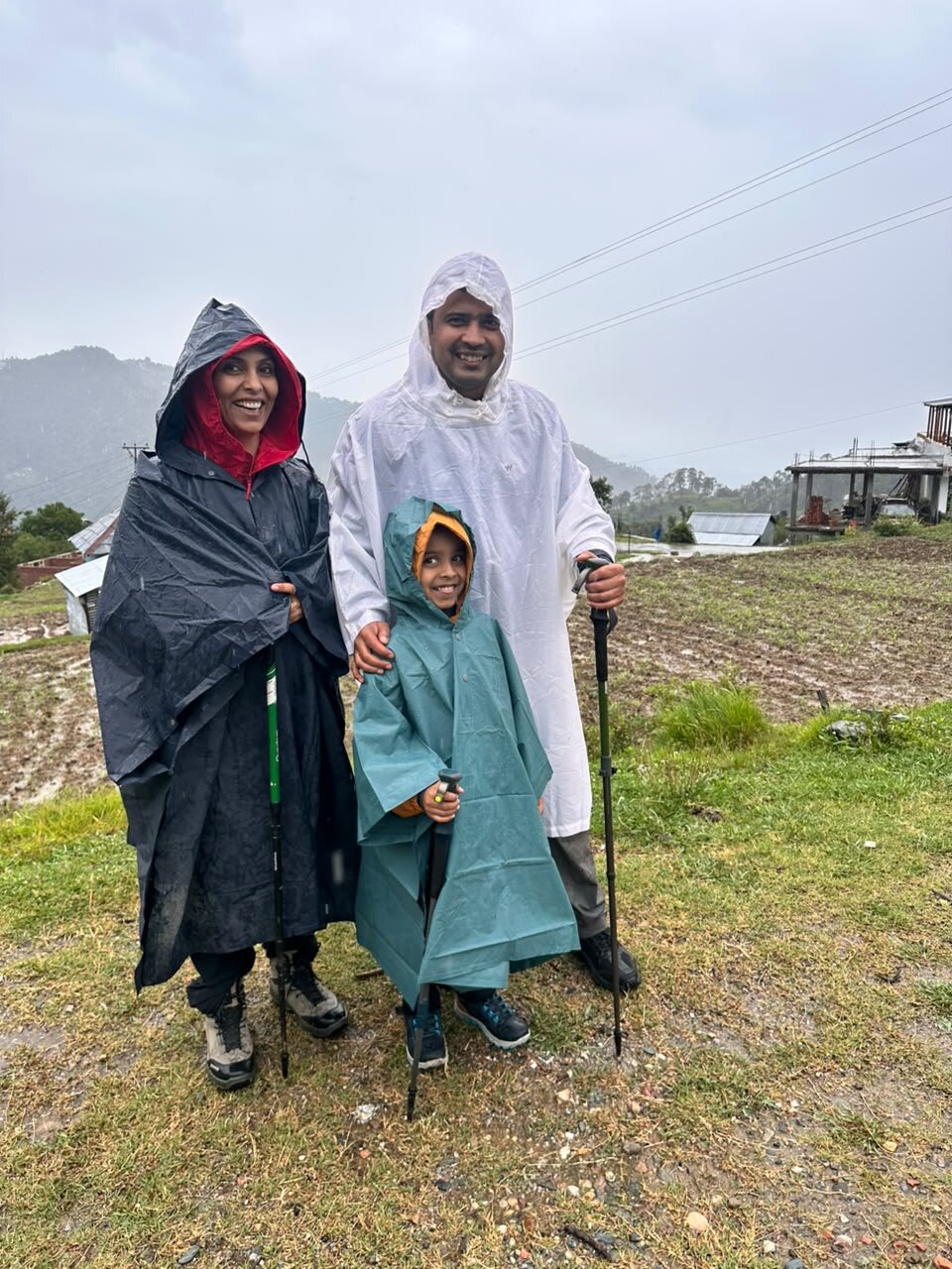 Yuvan with Ma and Papa in rain ponchos at the start of the Kareri Lake trek