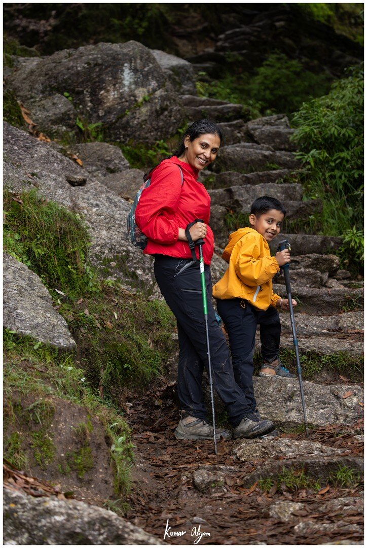 Yuvan and Ma climbing stone steps on the jungle trail