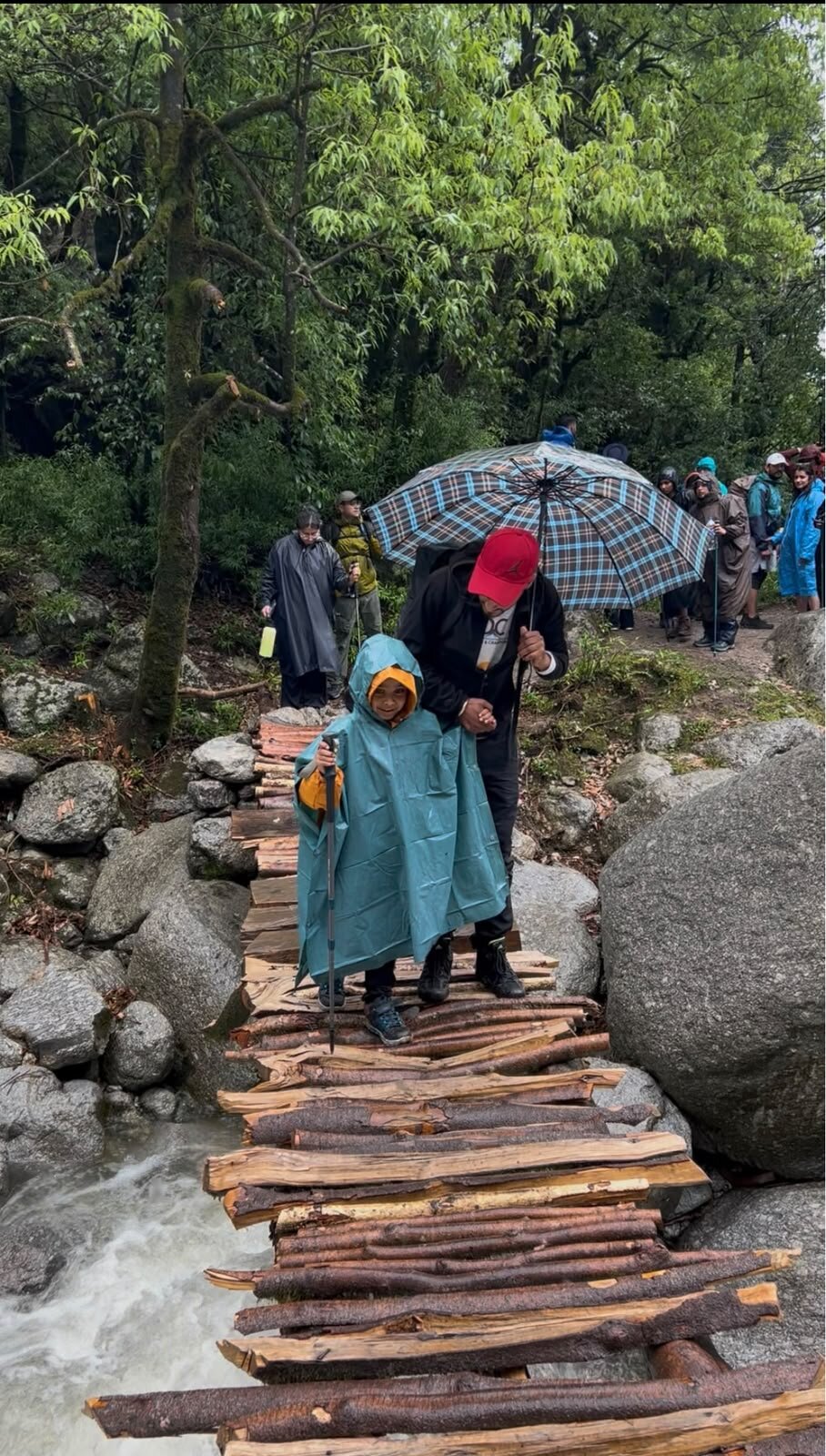 Yuvan standing on the scary wooden bridge with arms out