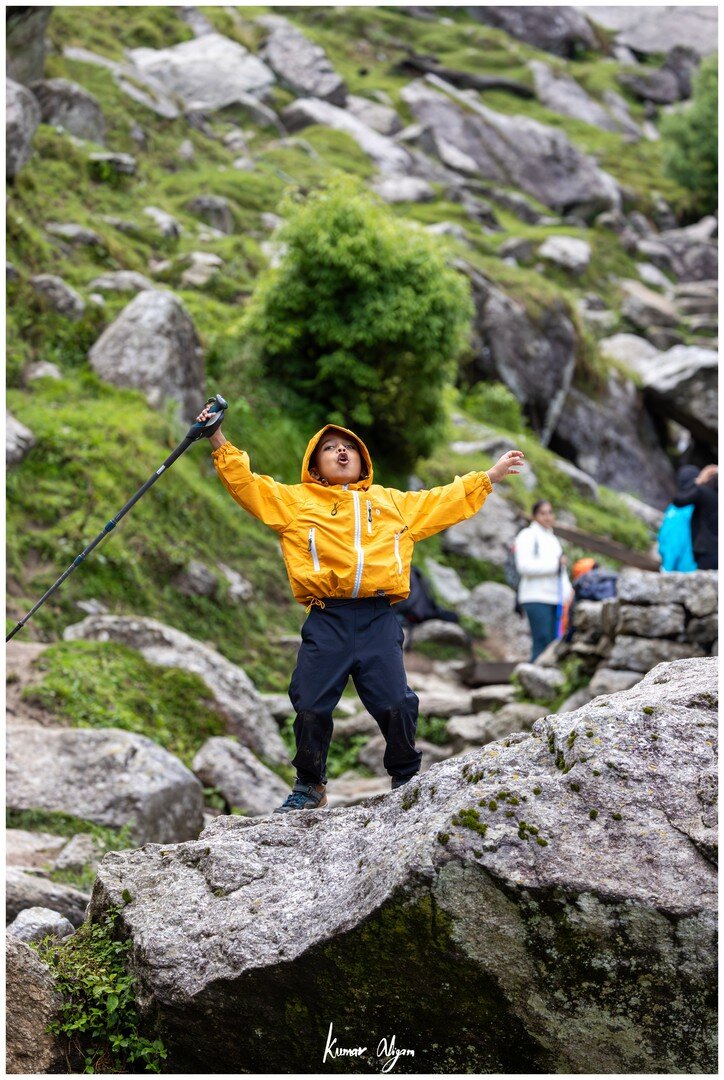 Yuvan cheering on a boulder along the trail