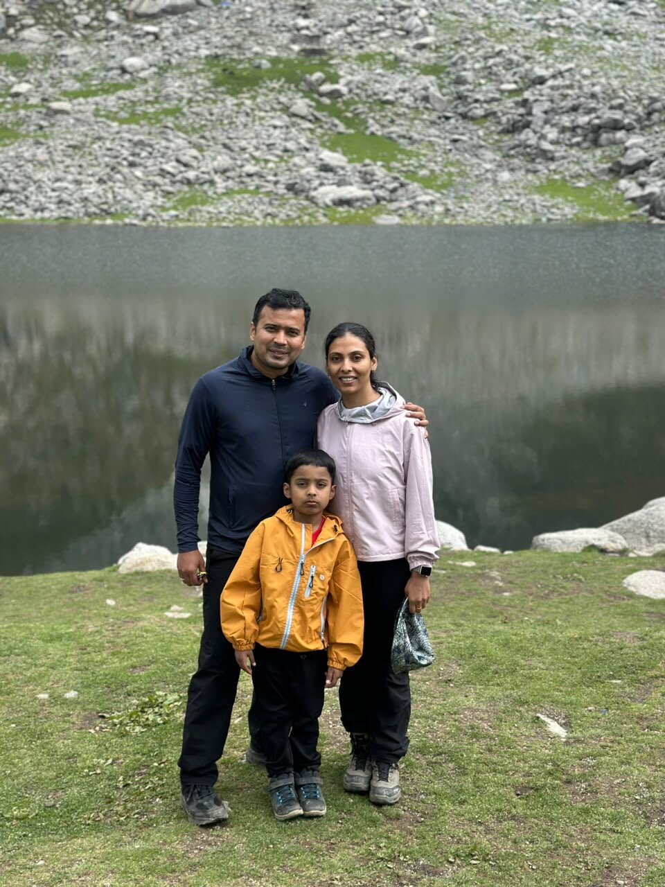 Yuvan with Ma and Papa standing together in front of Kareri Lake