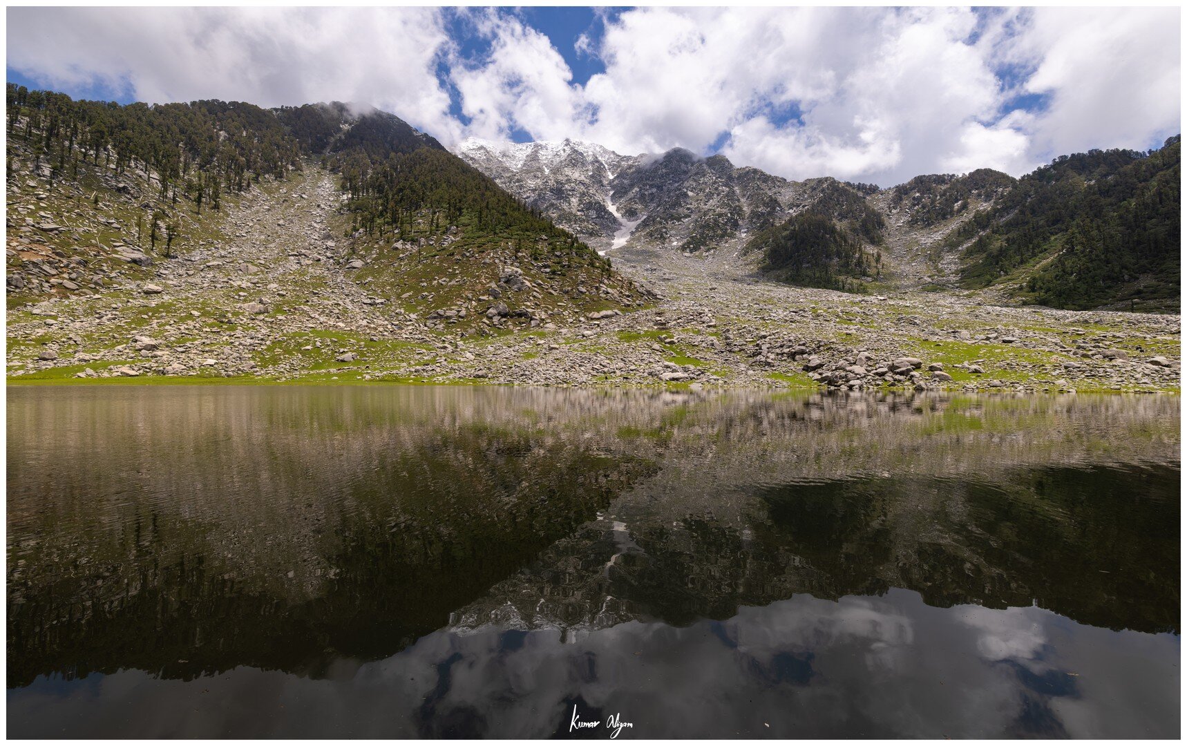 Kareri Lake with snow-covered mountains behind it