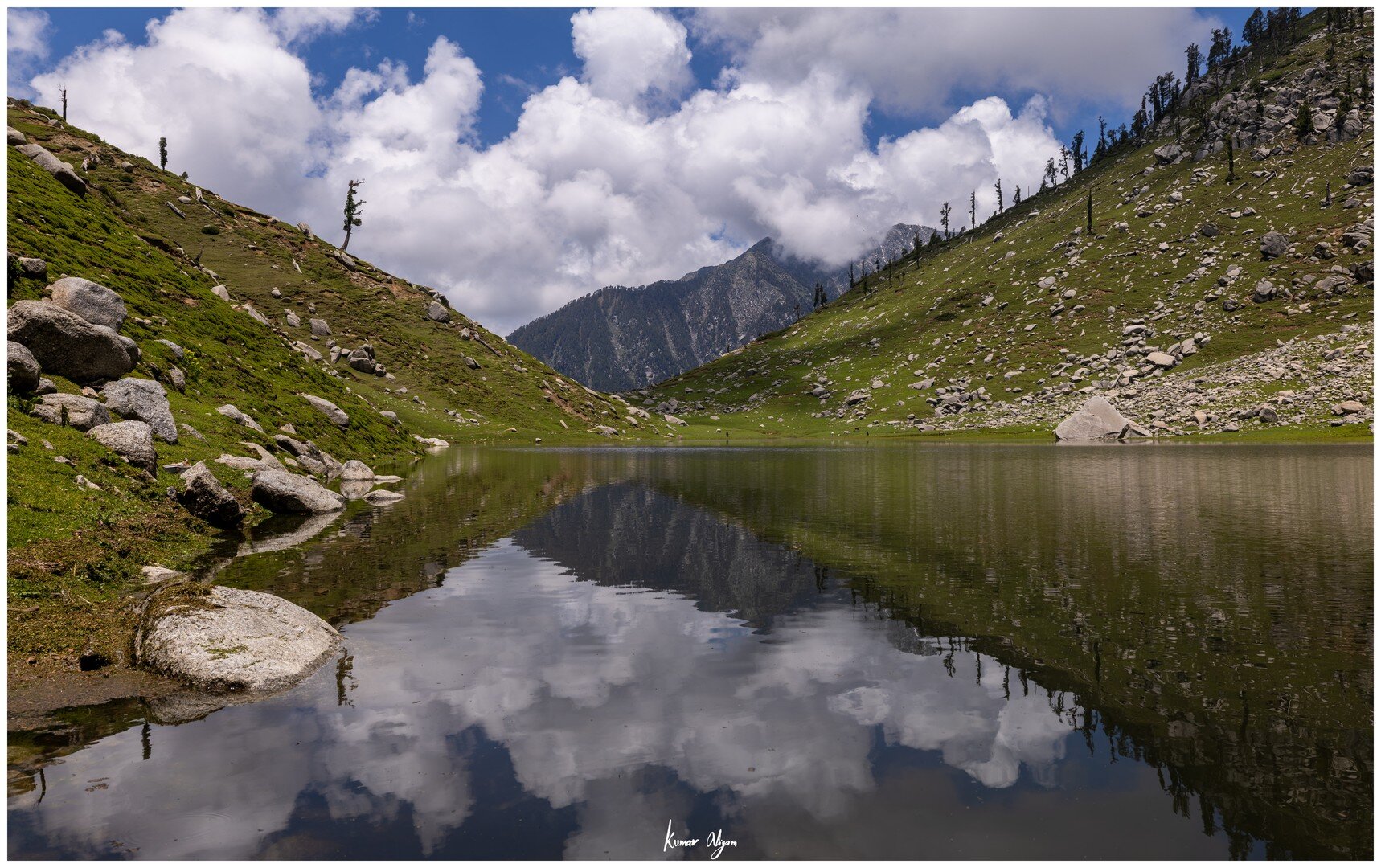 Clouds and mountains reflected perfectly in Kareri Lake
