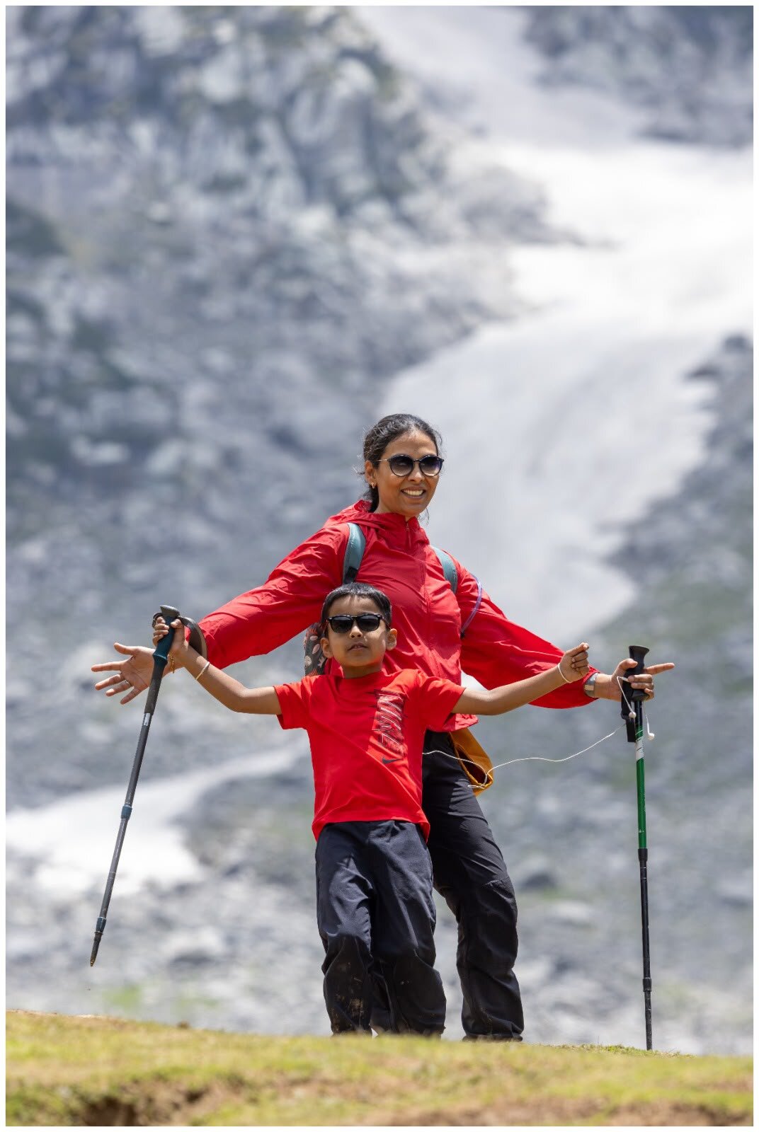 Yuvan and Ma in matching red doing their swag pose near Kareri Lake