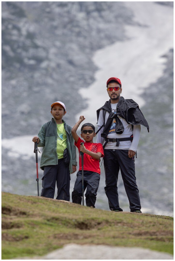 Yuvan, Zayra and the trek guide standing in front of the glacier