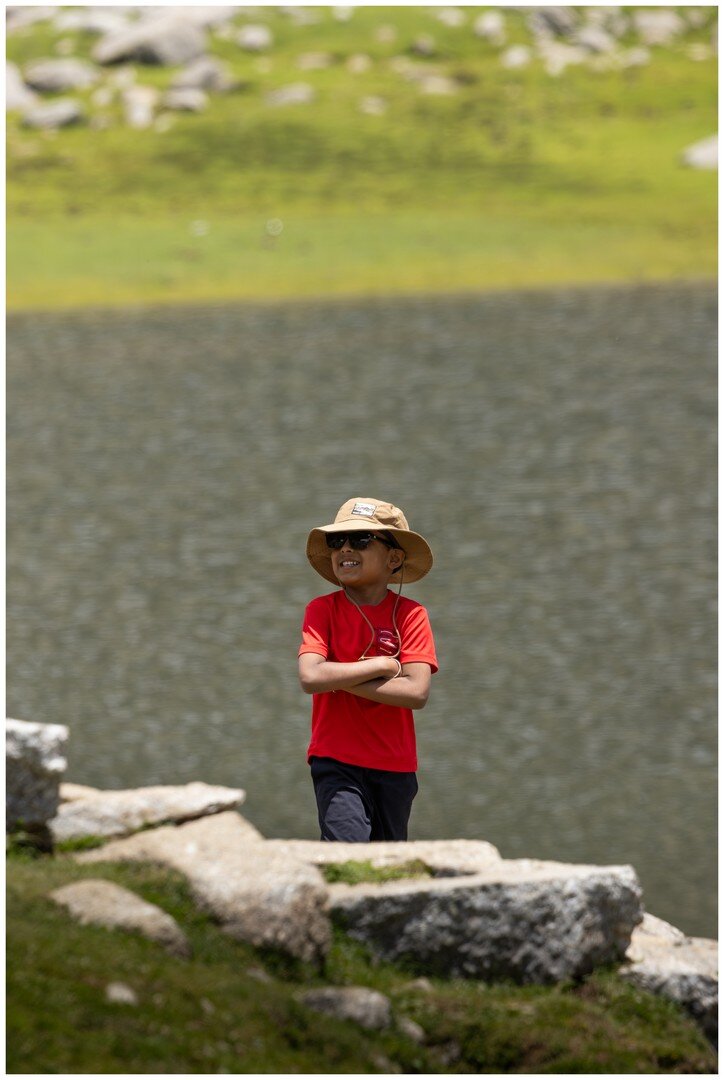 Yuvan standing by the edge of Kareri Lake in his hat