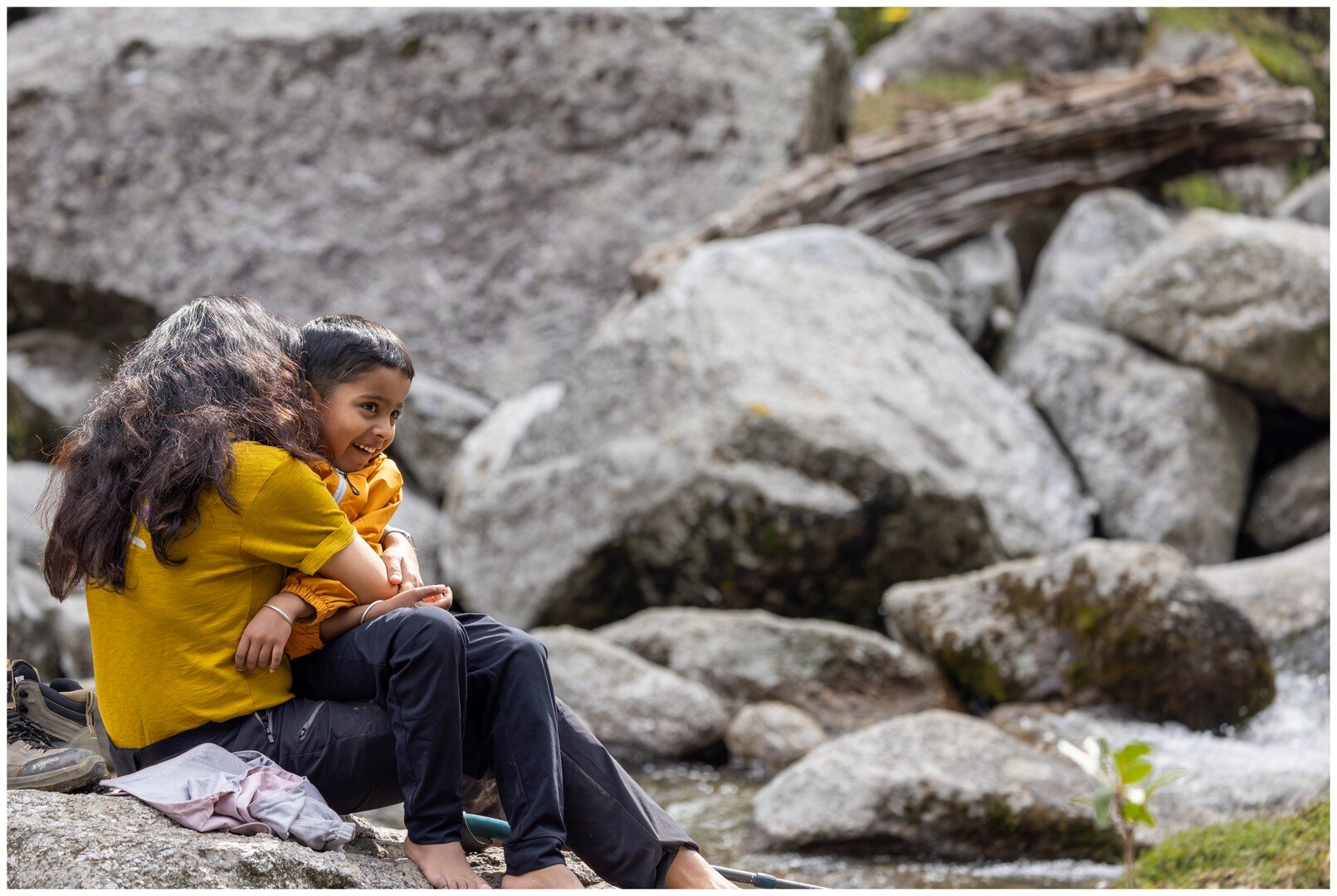 Ma hugging Yuvan by the stream